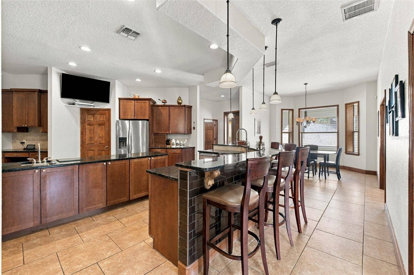 10484 GYPSY AVENUE, Weeki Wachee, FL 34613 BAR SEATING IN KITCHEN