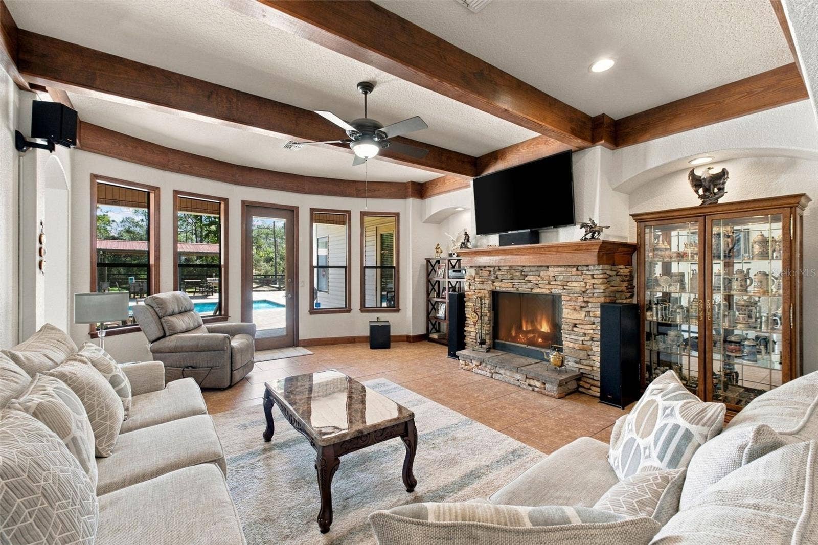 10484 GYPSY AVENUE, Weeki Wachee, FL 34613 FAMILY ROOM WITH WOOD BEAM CEILING AND GAS FIREPLACE