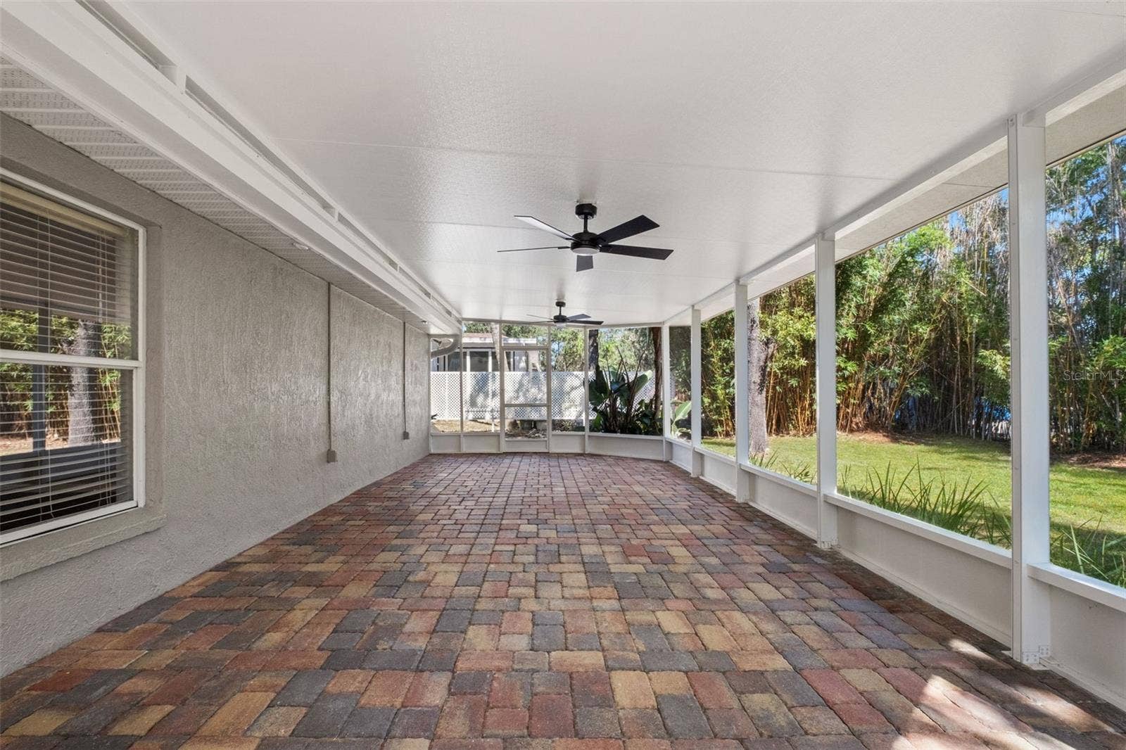 2138 FAIRVIEW ROAD, Spring Hill, FL 34609 Expansive Screened Rear Porch with Pavers