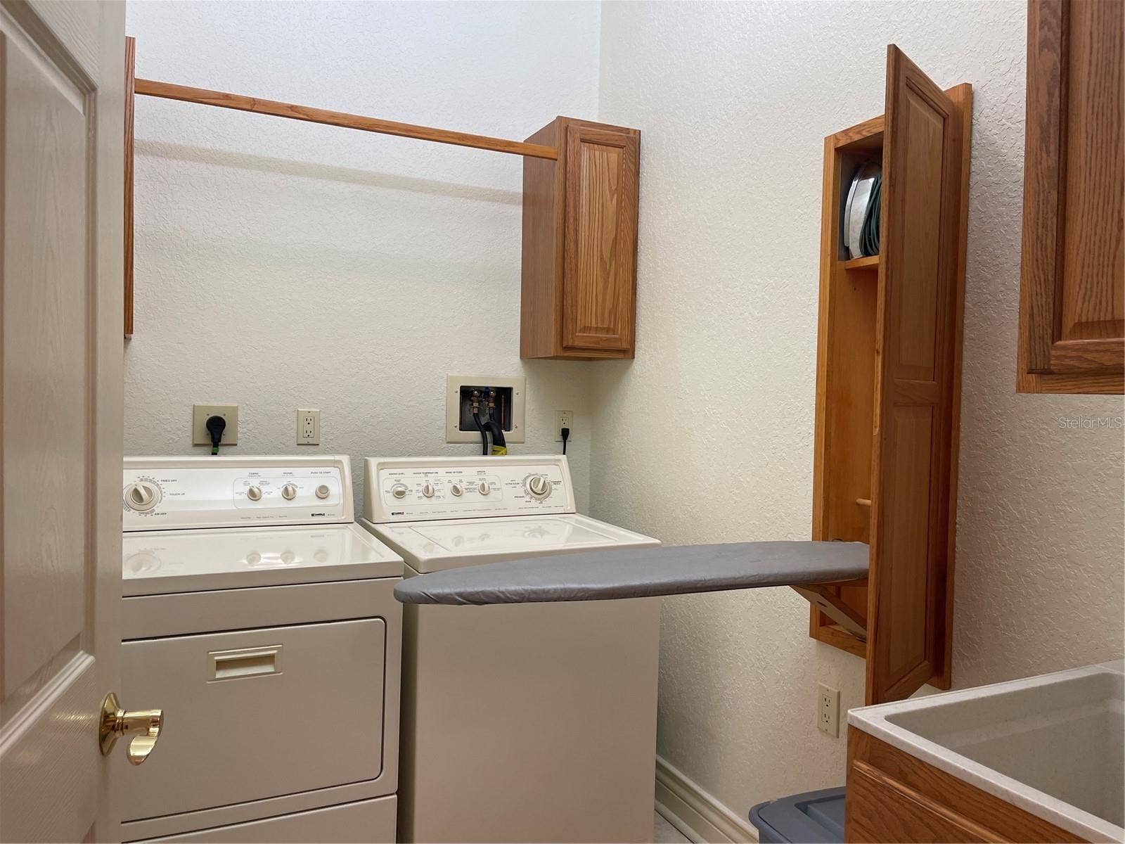 Washer, dryer and stand up sink in laundry room on second floor