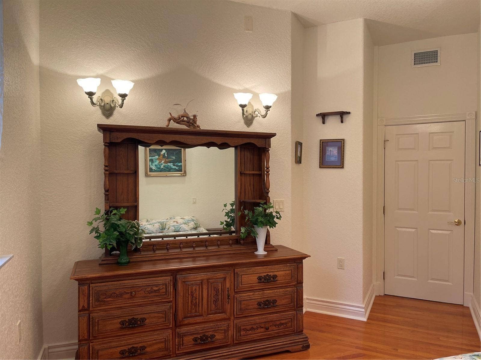 2nd bedroom features four sconse lights.