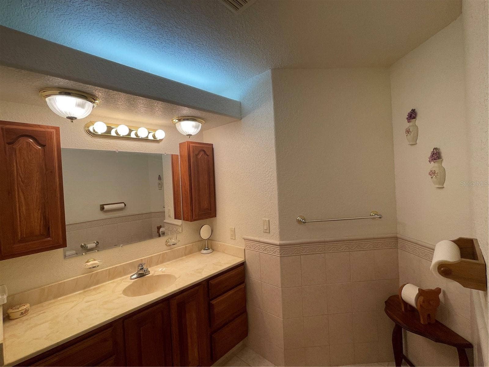 Guest bathroom has hard wood cabinets