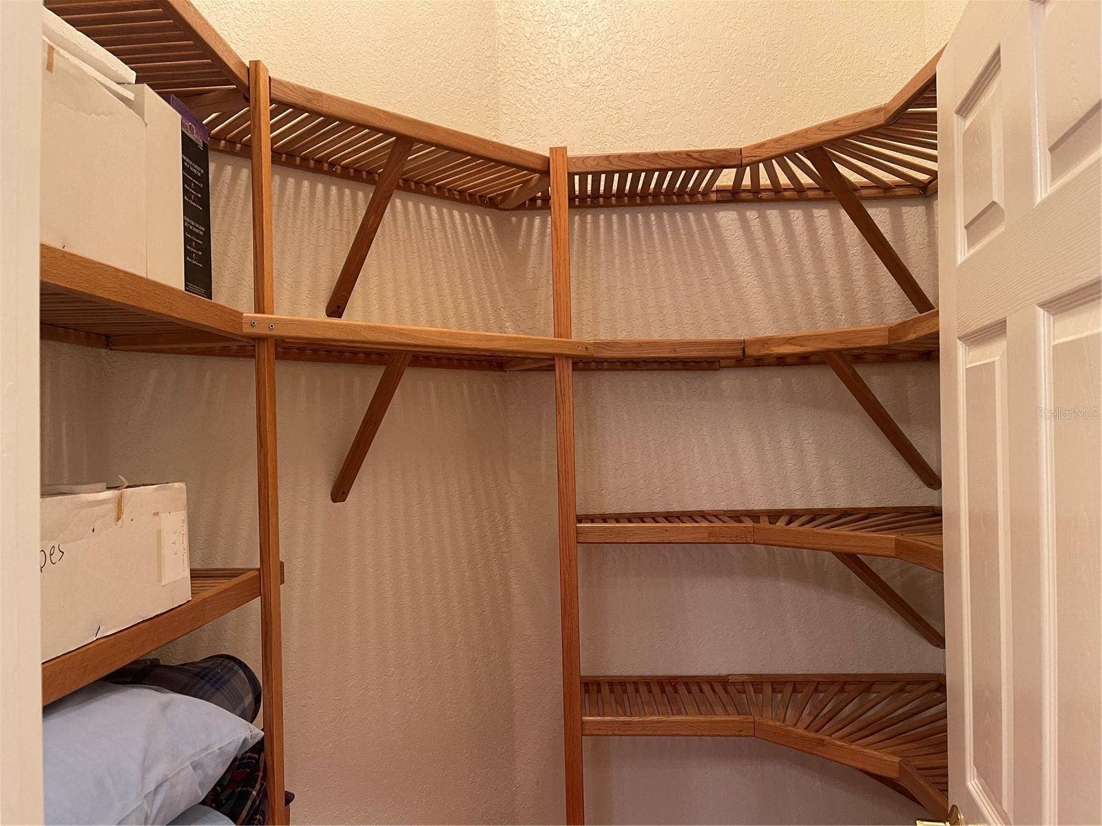 Closet has wood shelving