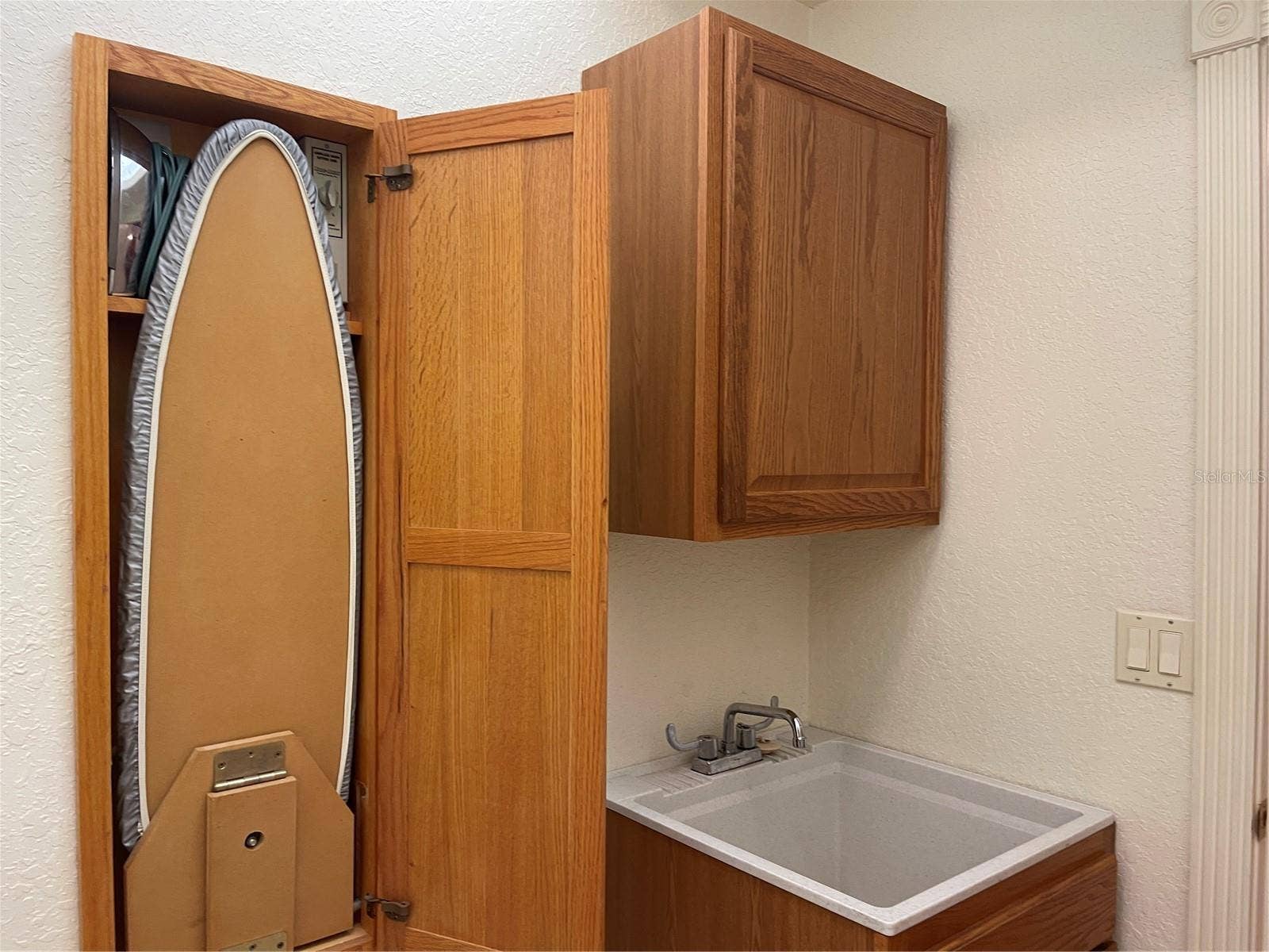 Wall cabinet for fold out ironing board, iron and built in light.