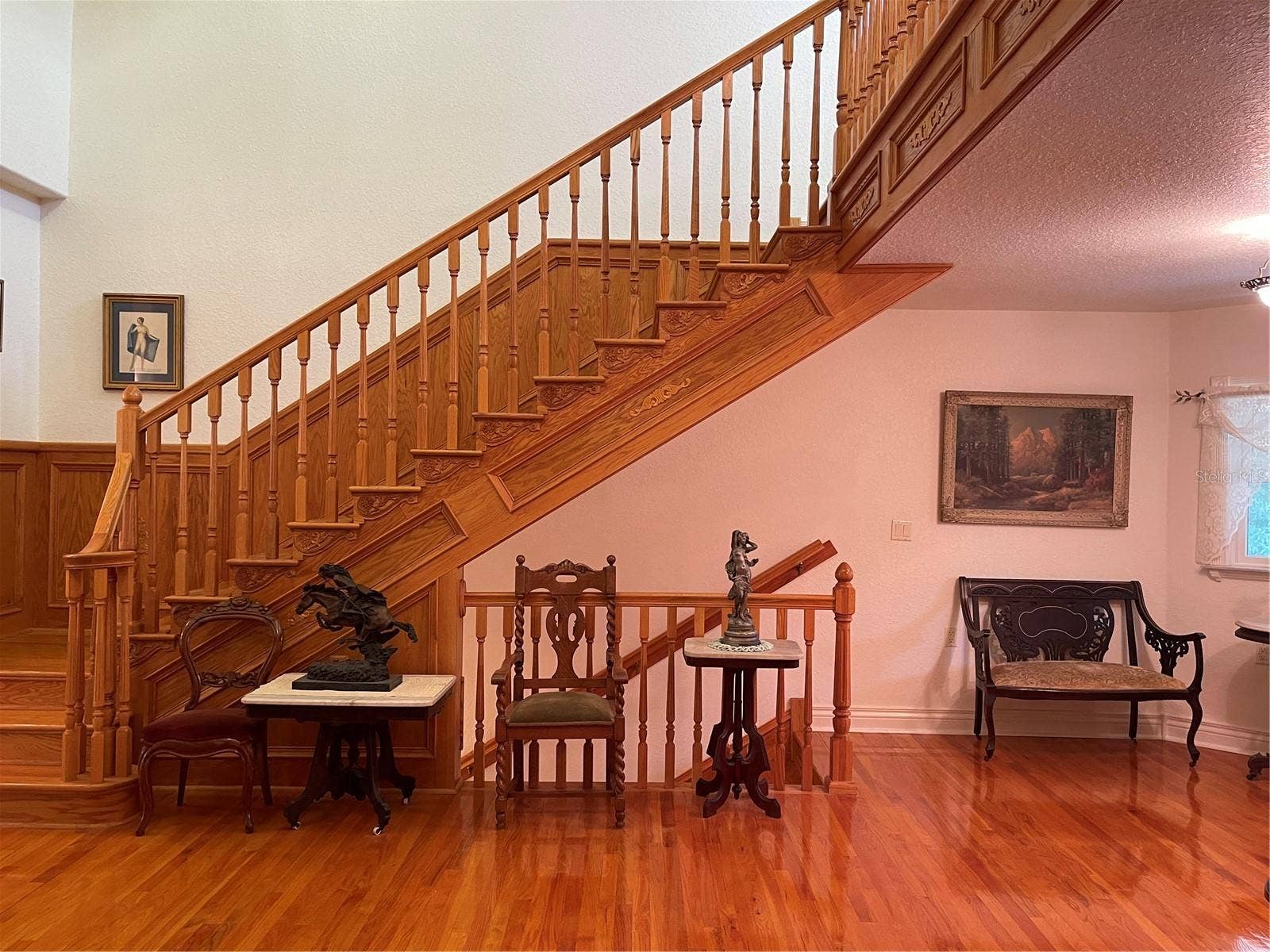 Admiring solid wood staircase and wood accents.