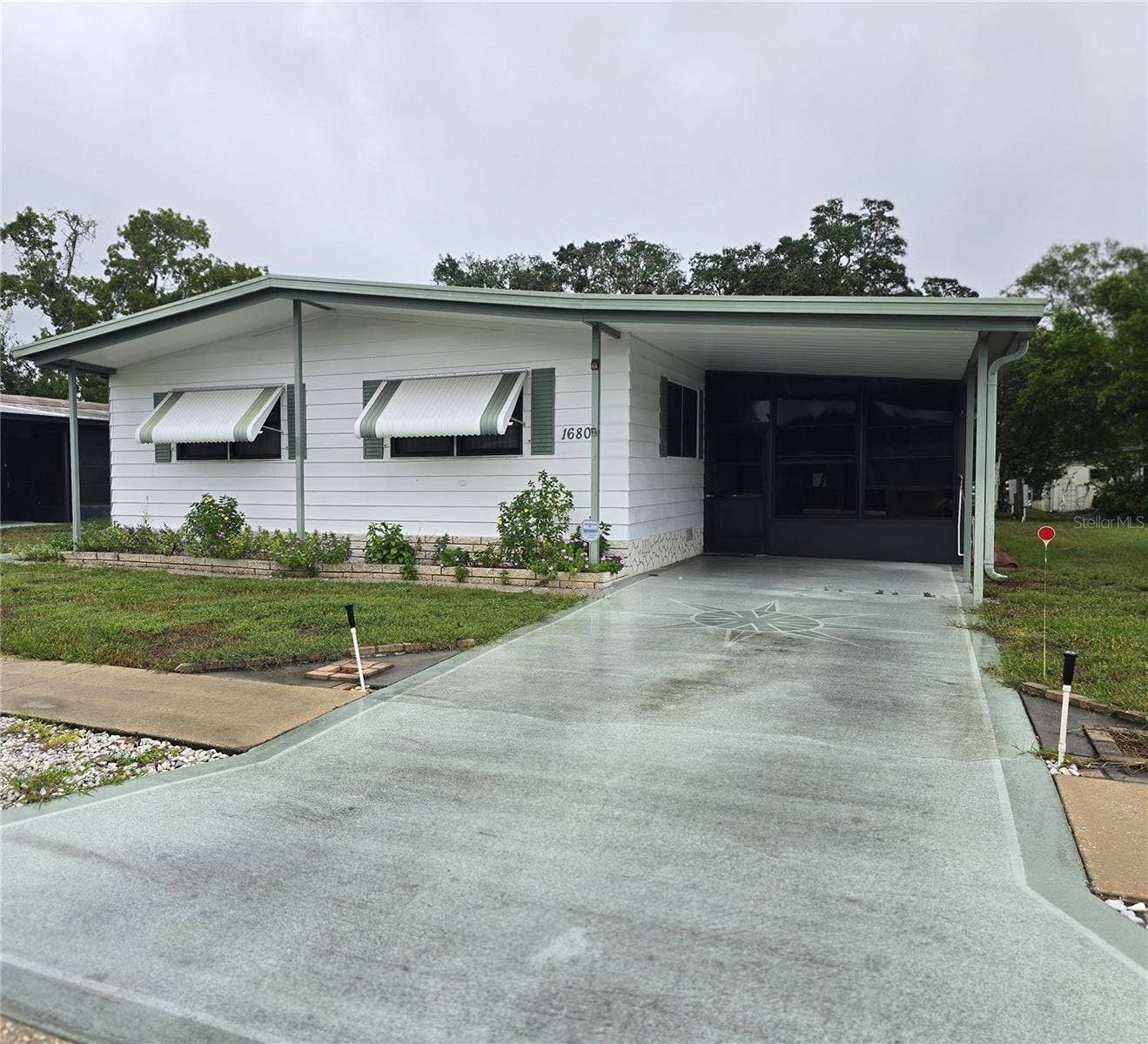 16802 HARLEY STREET, Hudson, FL 34667 VIEW OF CARPORT & FRONT EXTERIOR