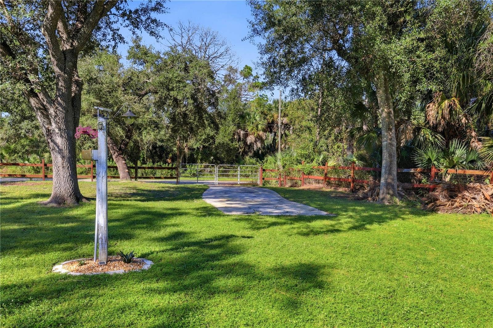 Rear entrance to property with gate. parking pad and RV hookup.