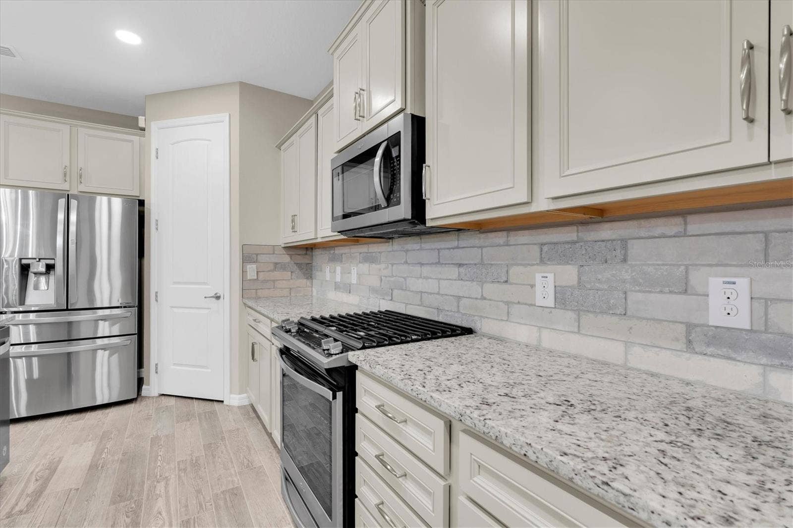 Kitchen appliances and tile backsplash