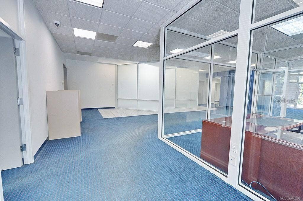 10241 N FLORIDA AVENUE, Citrus Springs, FL 34434 Open customer area with glass-partitioned office space.