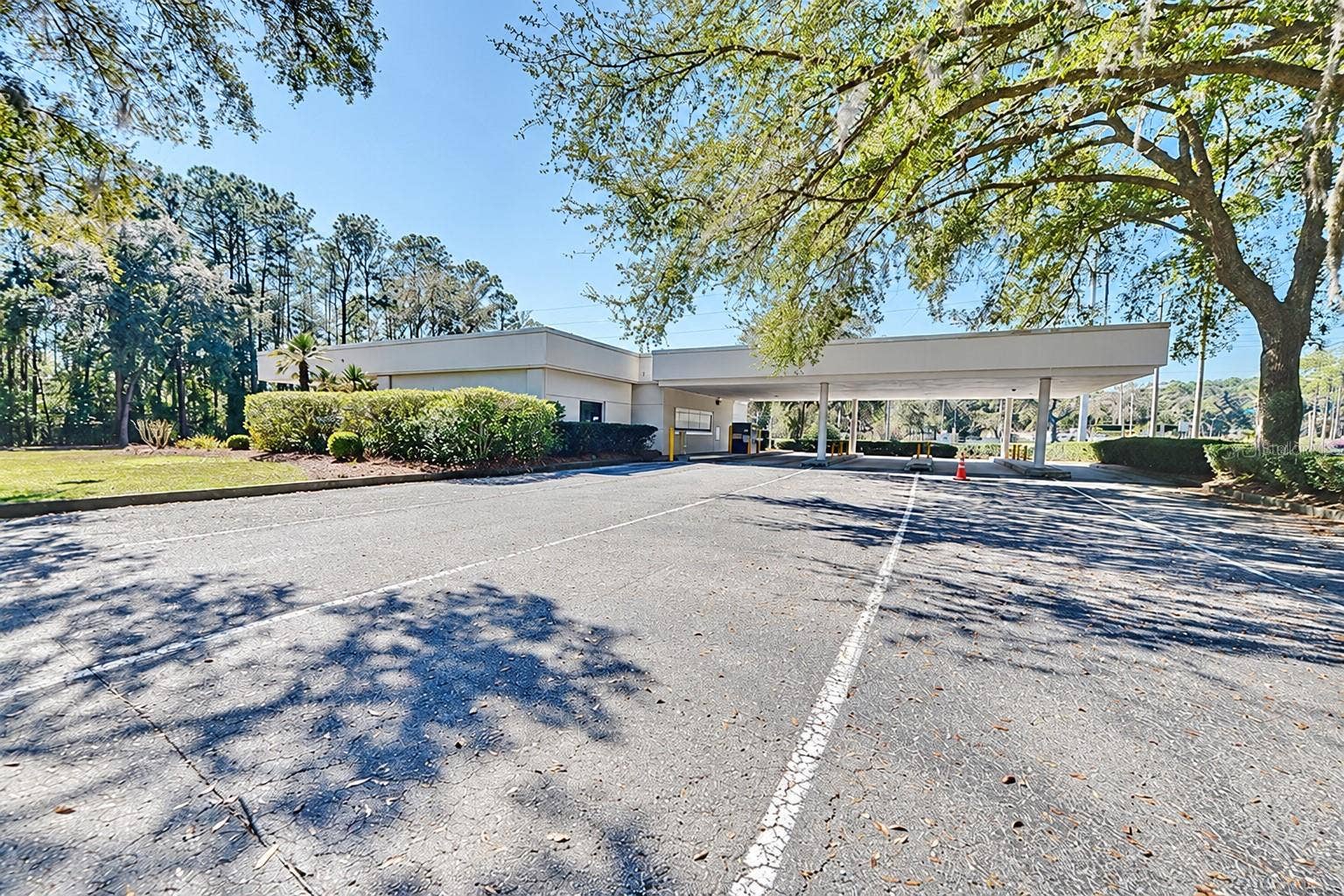 10241 N FLORIDA AVENUE, Citrus Springs, FL 34434 Rear view of the covered drive-through lanes. Digitally edited to remove former bank signage.