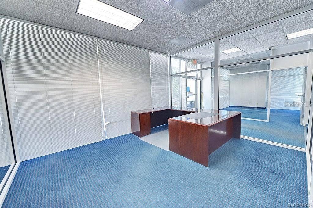 10241 N FLORIDA AVENUE, Citrus Springs, FL 34434 Glass-partitioned office with views across the interior.