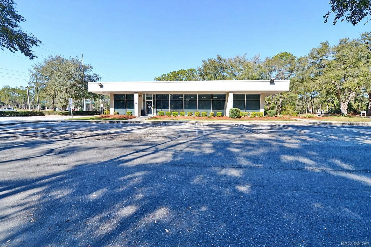 10241 N FLORIDA AVENUE, Citrus Springs, FL 34434 Front elevation with a broad window line and customer entrance. Digitally edited to remove former bank signage.