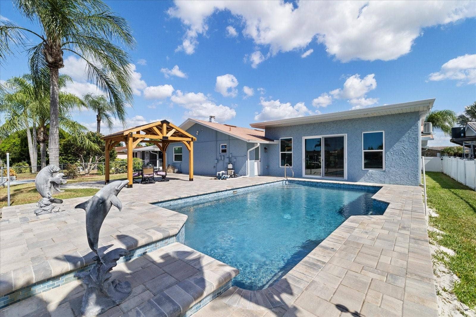 5001 MARLIN DRIVE, New Port Richey, FL 34652 Dolphin statues on waterfall feature pool