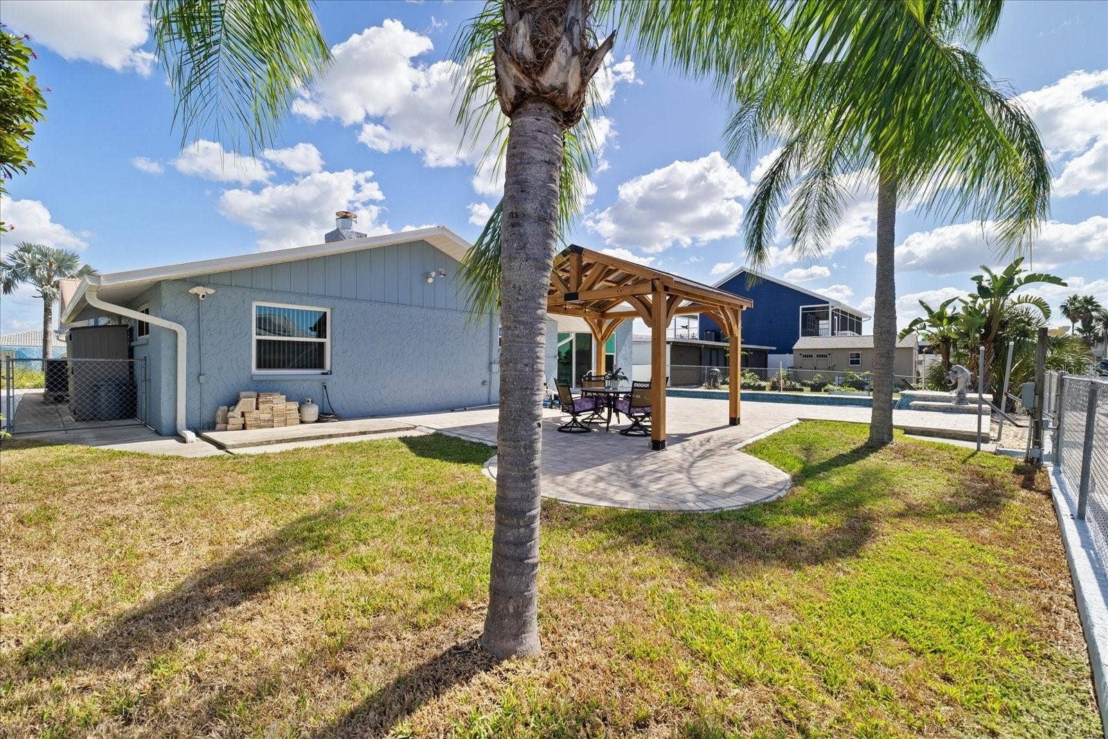 5001 MARLIN DRIVE, New Port Richey, FL 34652 Grassy backyard area and palms