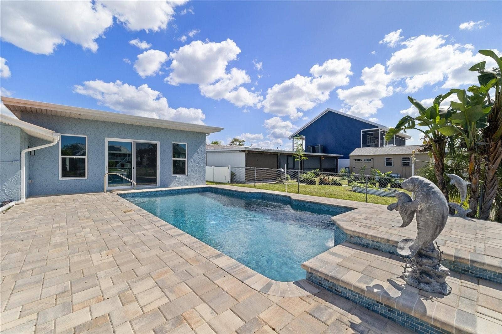 5001 MARLIN DRIVE, New Port Richey, FL 34652 Pavered pool deck with dolphin accents and waterfall feature