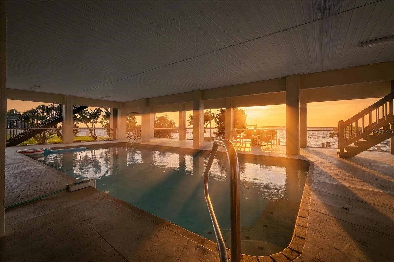 5767 WESTSHORE DRIVE, New Port Richey, FL 34652 Virtually Edited, covered pool at sunset