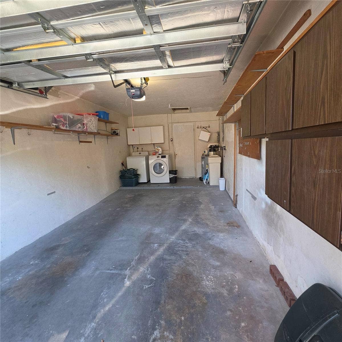 2101 SUNSET POINT ROAD, #2603, Clearwater, FL 33765 Garage with cabinets and washer and dryer