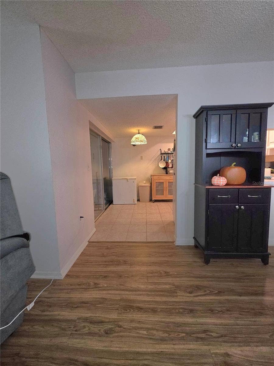 2101 SUNSET POINT ROAD, #2603, Clearwater, FL 33765 Dining room looking into eat in kitchen.