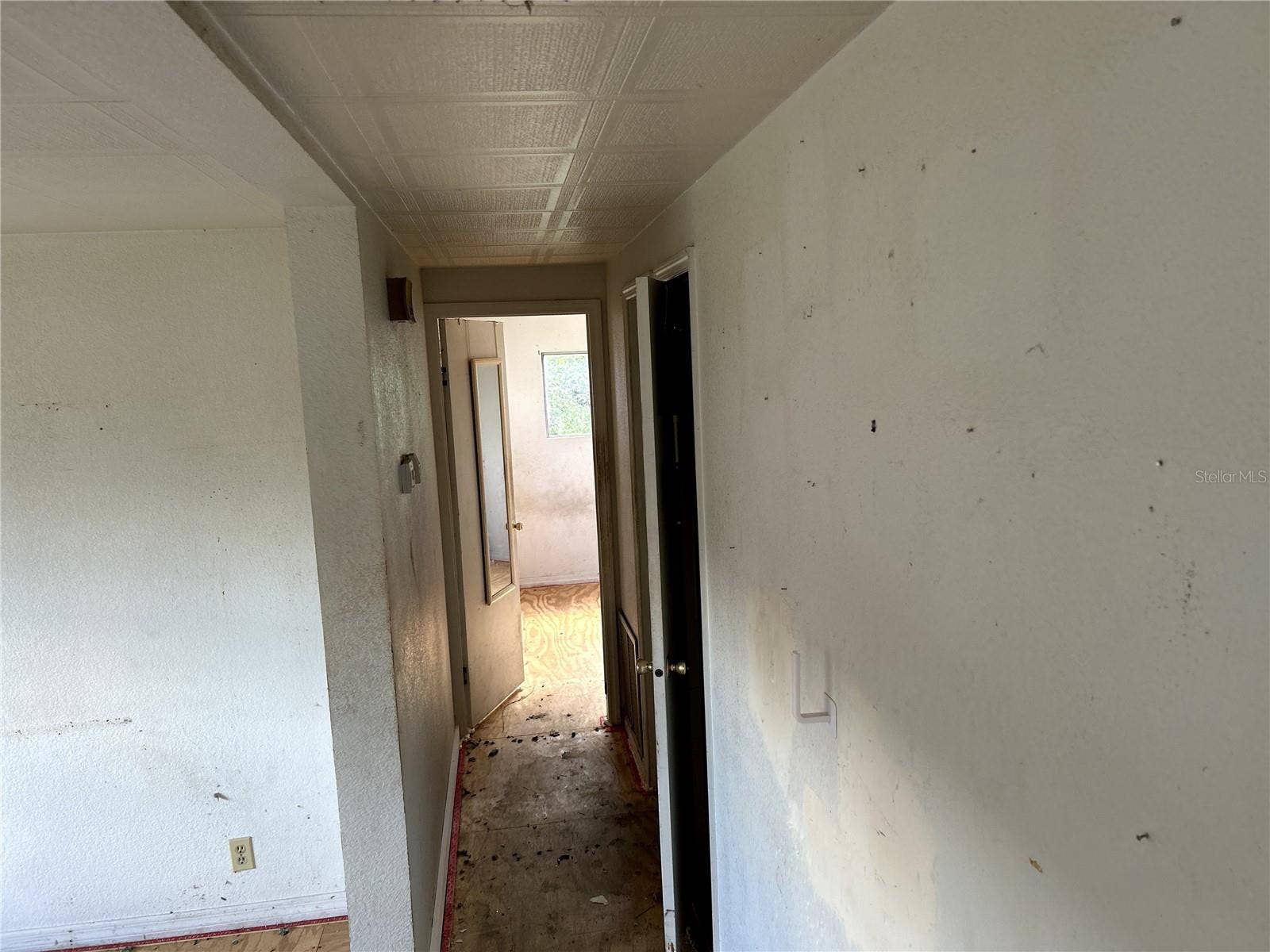 14506 DEHAVEN AVENUE, Brooksville, FL 34613 view down hall into primary bedroom