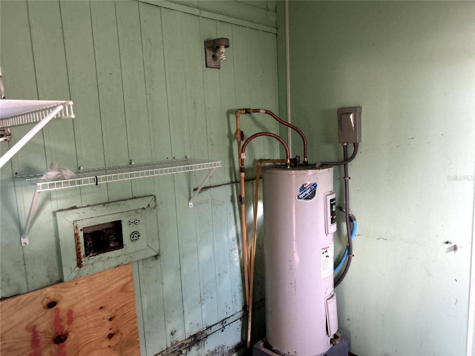 14506 DEHAVEN AVENUE, Brooksville, FL 34613 utility / laundry room with water heater, electric dryer hook up and washer hook ups