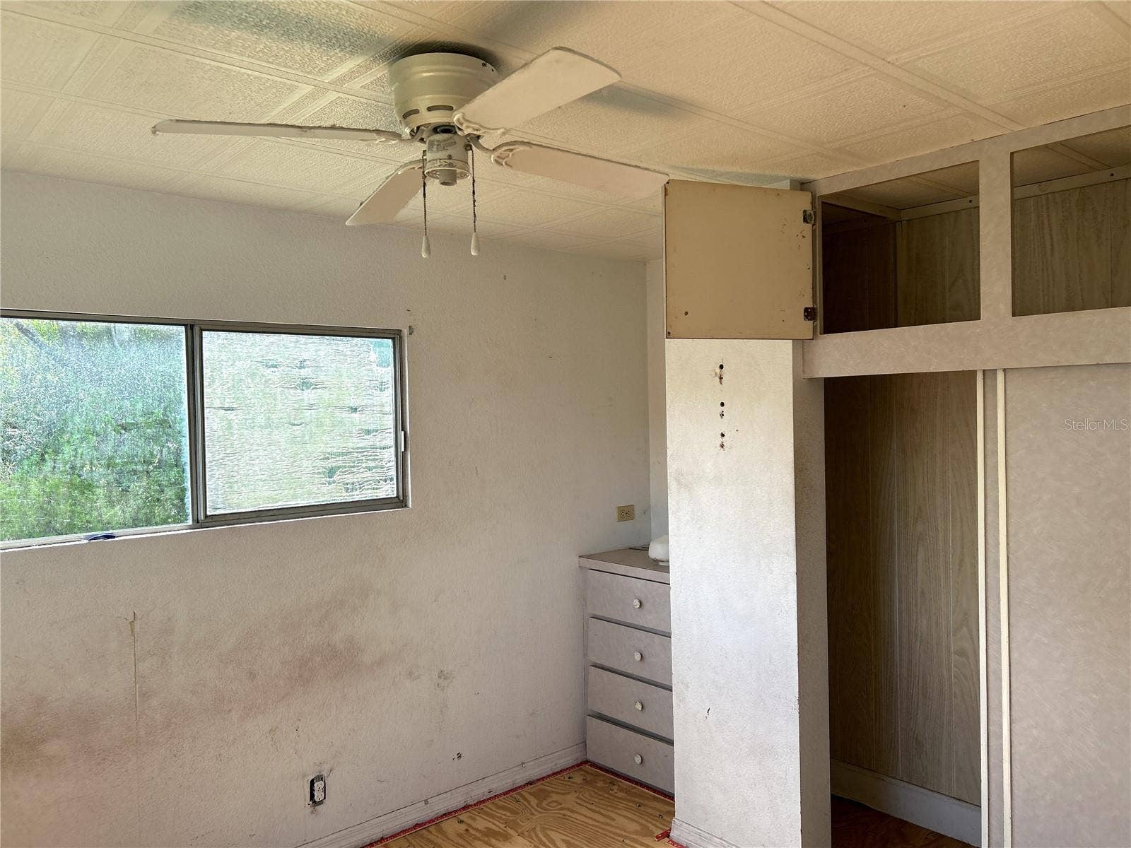14506 DEHAVEN AVENUE, Brooksville, FL 34613 primary bedroom with built in closet and drawers at back of home.