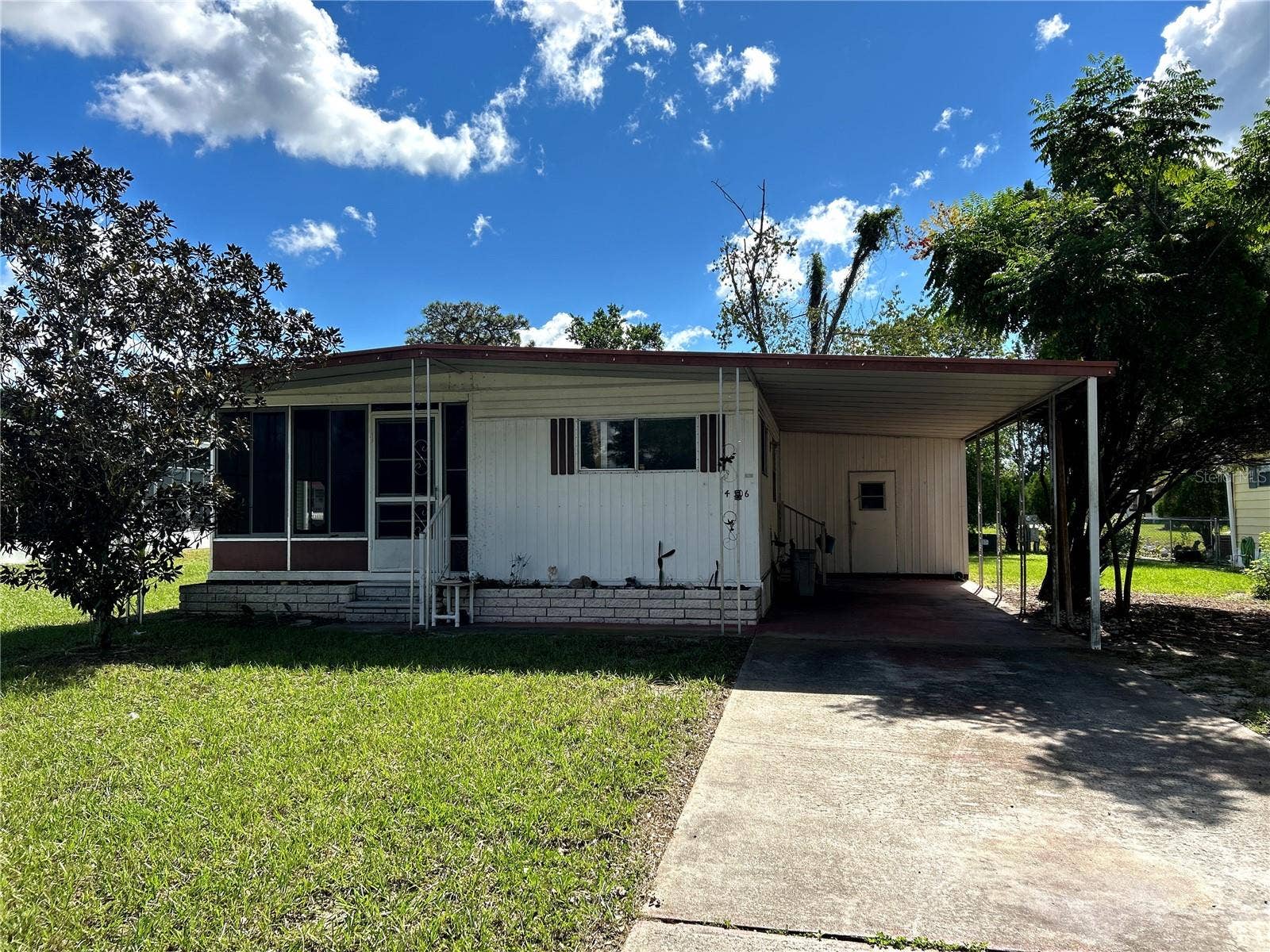 14506 DEHAVEN AVENUE, Brooksville, FL 34613 Investor Special! CASH Only. Front view, paved drive, carport, screened porch.