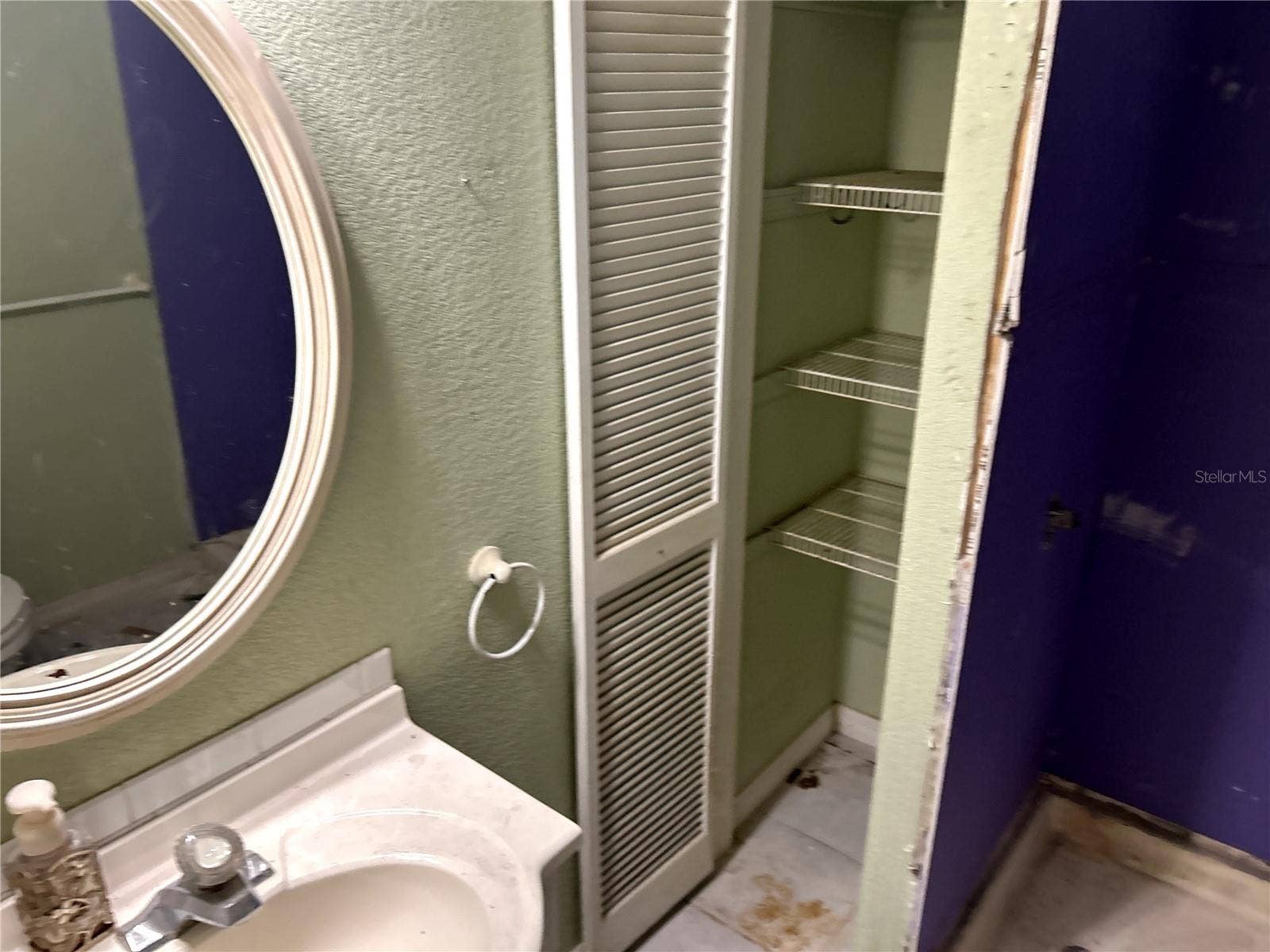14506 DEHAVEN AVENUE, Brooksville, FL 34613 full bathroom with single vanity, linen closet, walk-in shower and toilet.