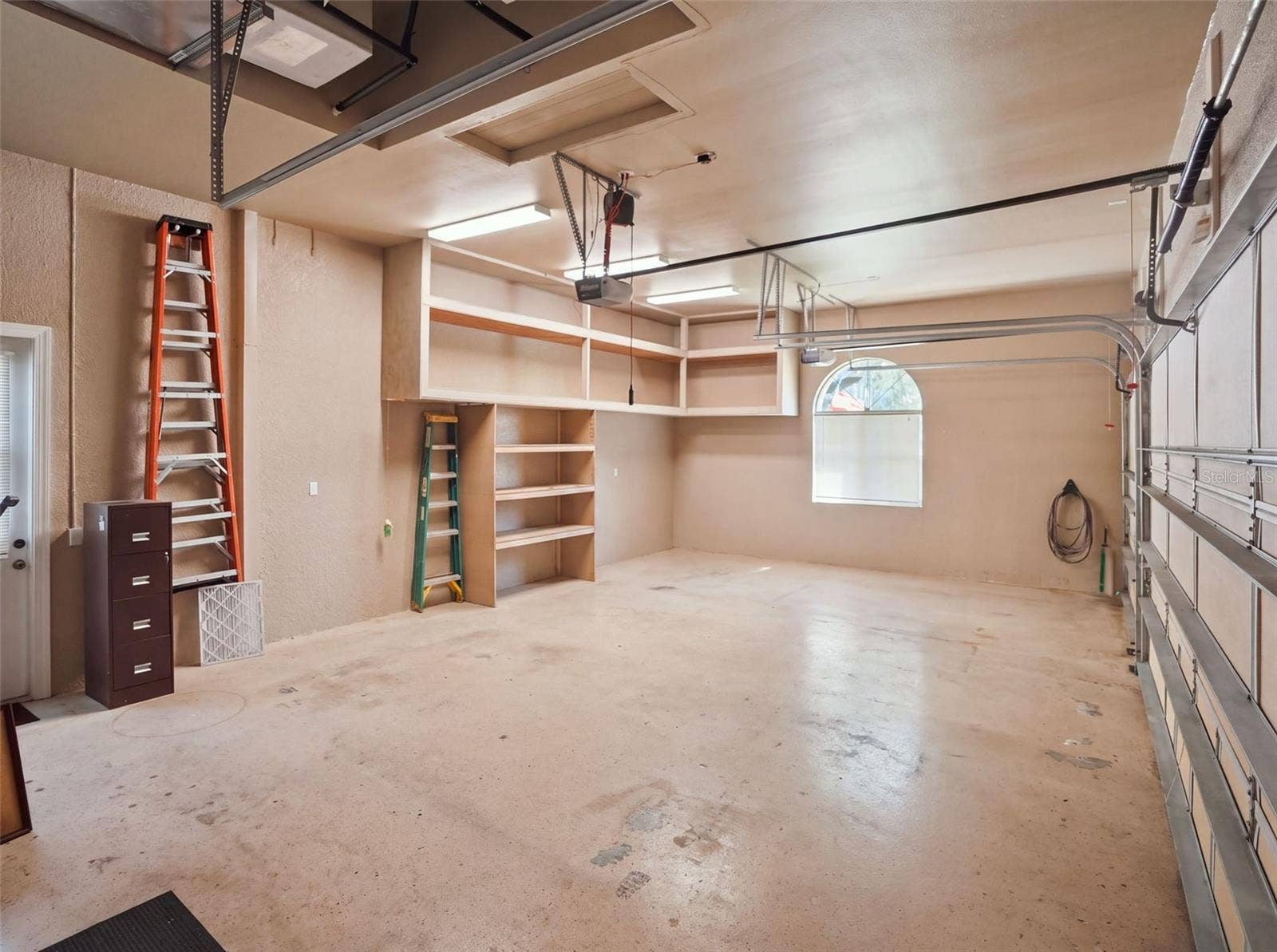 9313 HERNANDO RIDGE ROAD, Weeki Wachee, FL 34613 Large and deep 3-car garage with extra tall doors for large trucks/vehicles.