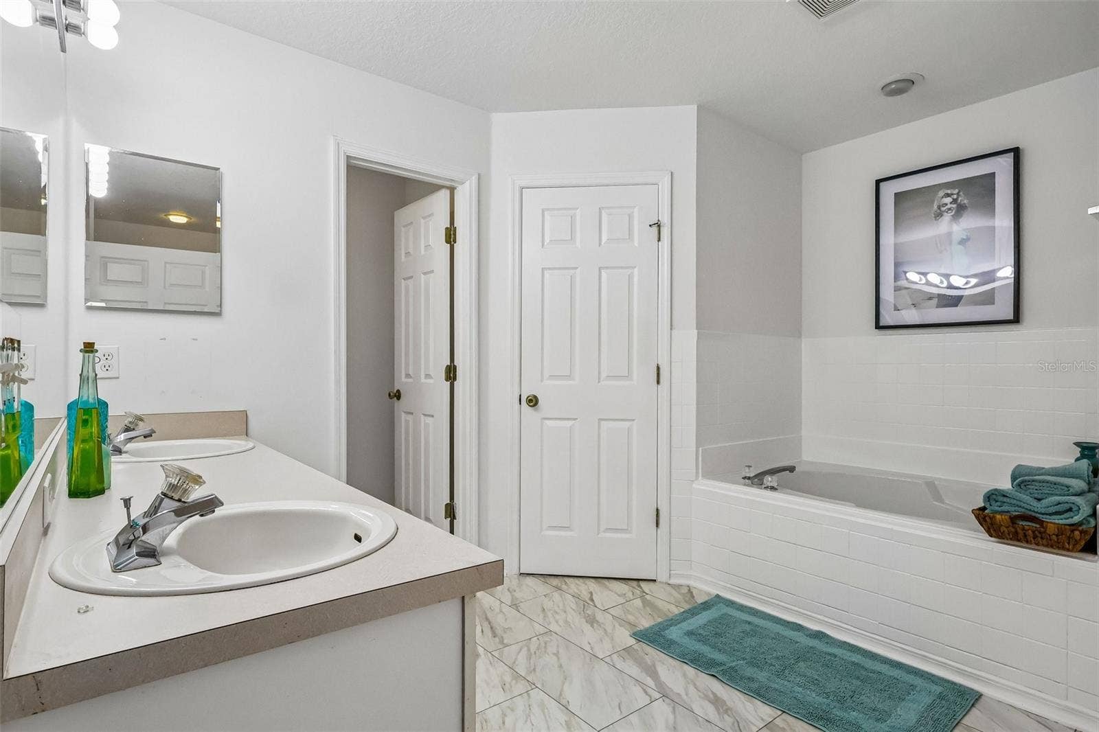Master bath with water closet, stand up shower, soaking tub, and two walk-in closets.