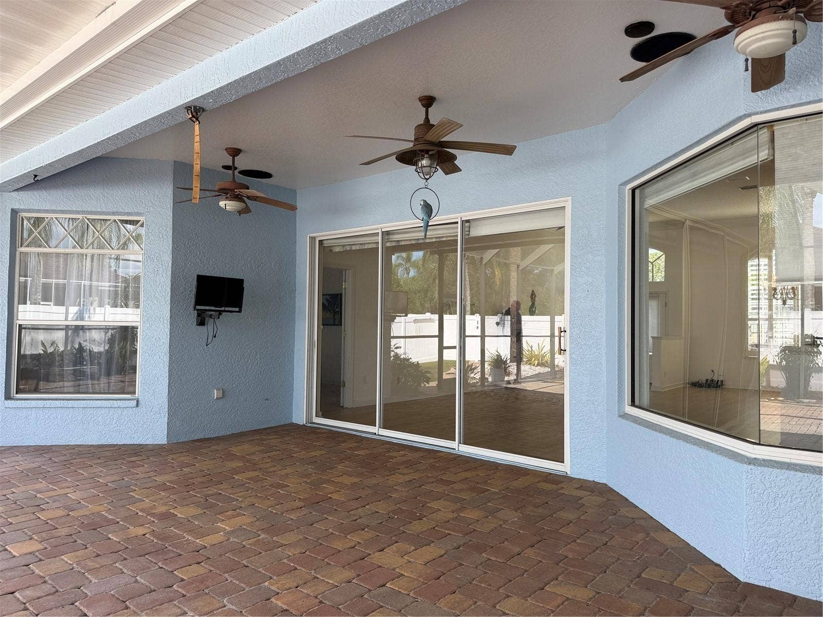 Patio Covered lanai with two ceiling fans and a TV.