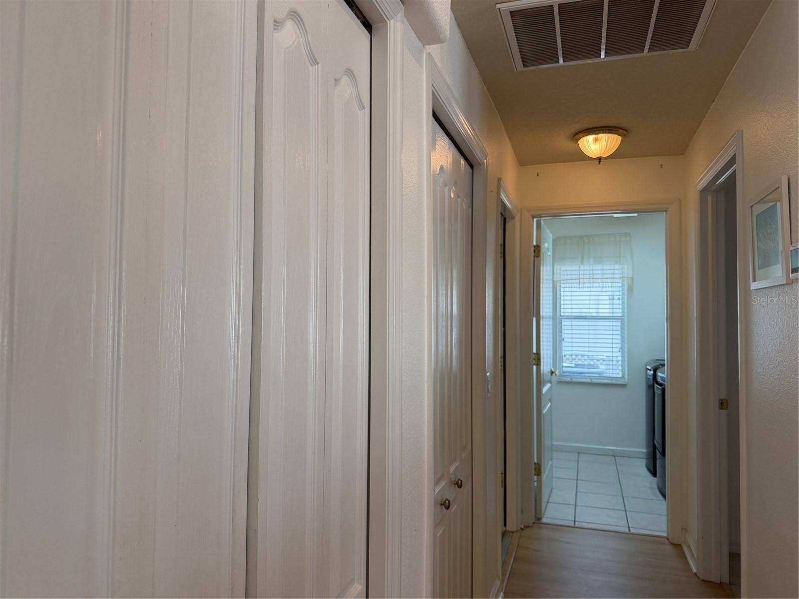 Beyond closets to the left is a door that enters bonus room and garage. Straight ahead is indoor laundry room. Door to right leads to 2nd bedroom