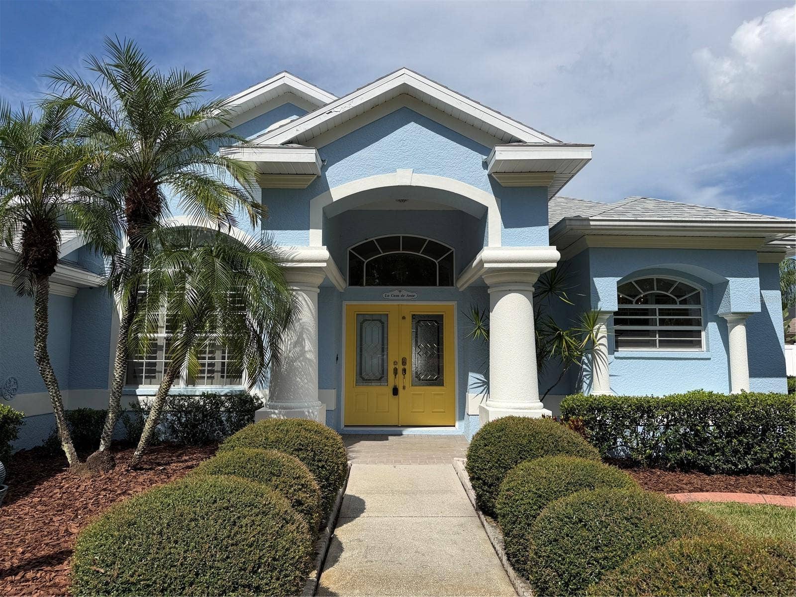 Columns and double door entry at front of home