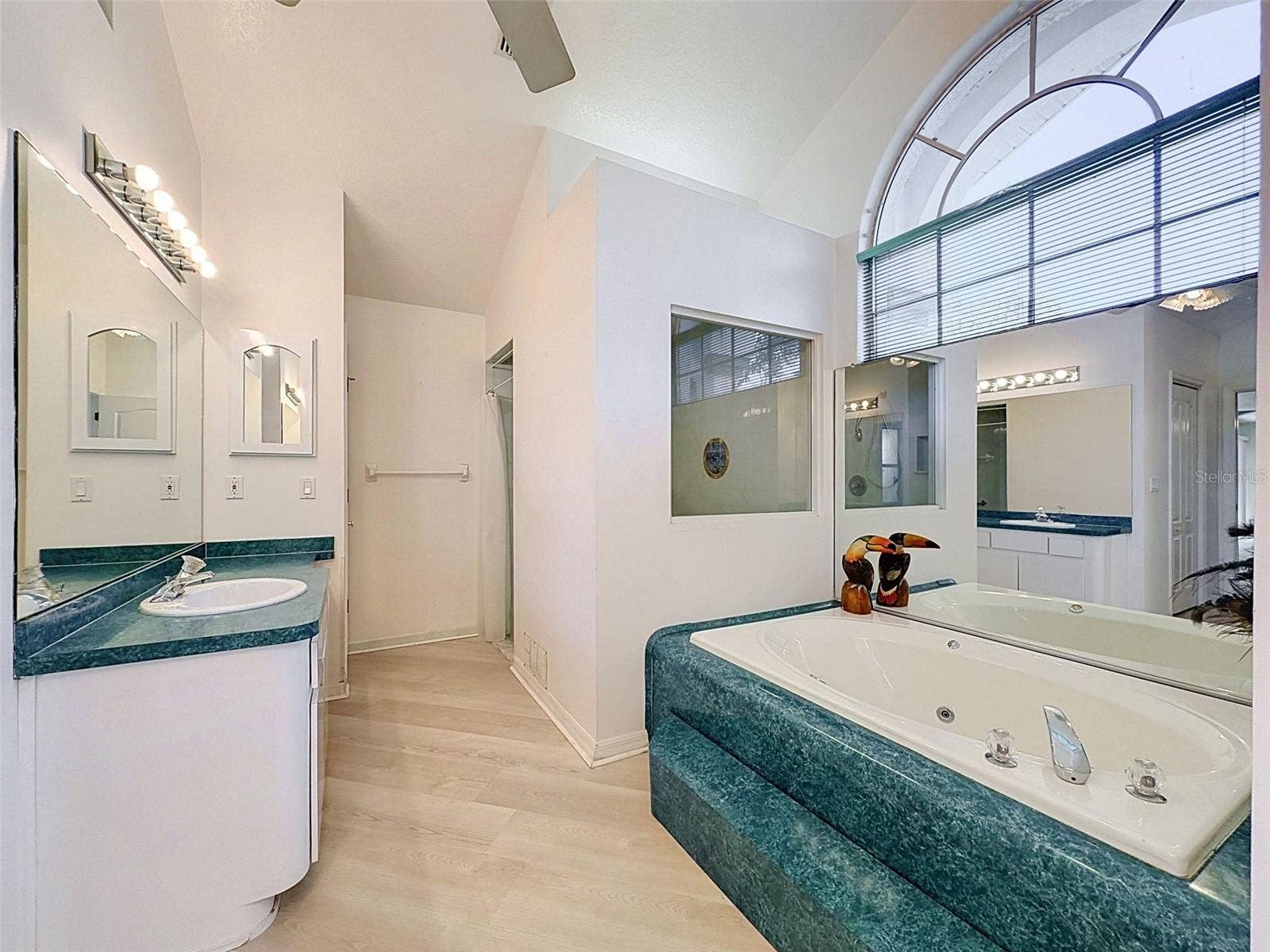 10074 SLEEPY WILLOW COURT, Spring Hill, FL 34608 Owner's suite includes jetted tub, two WICs, linen closet, water closet, two vanities, and large shower.