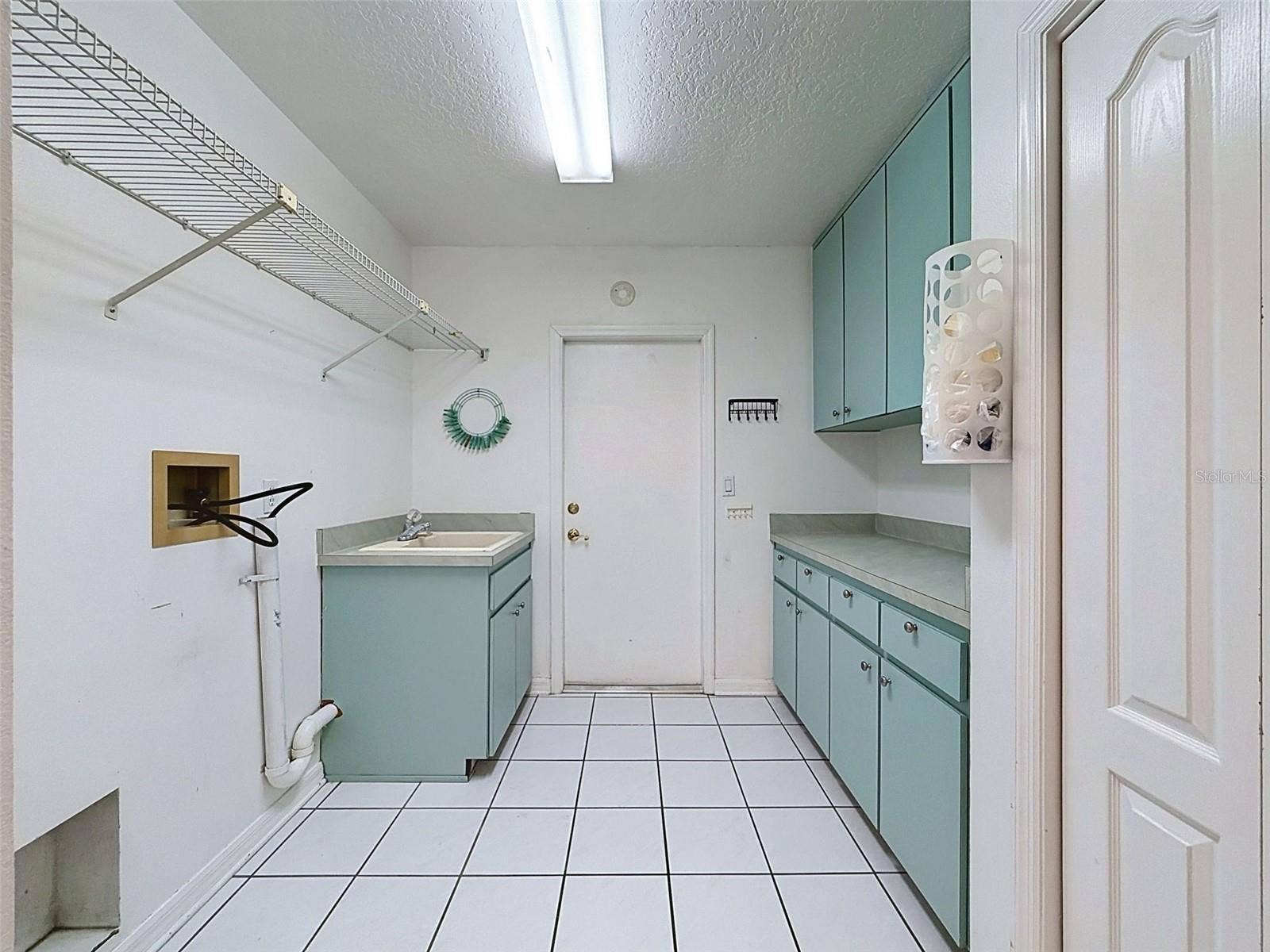 10074 SLEEPY WILLOW COURT, Spring Hill, FL 34608 Laundry room has storage gallore!