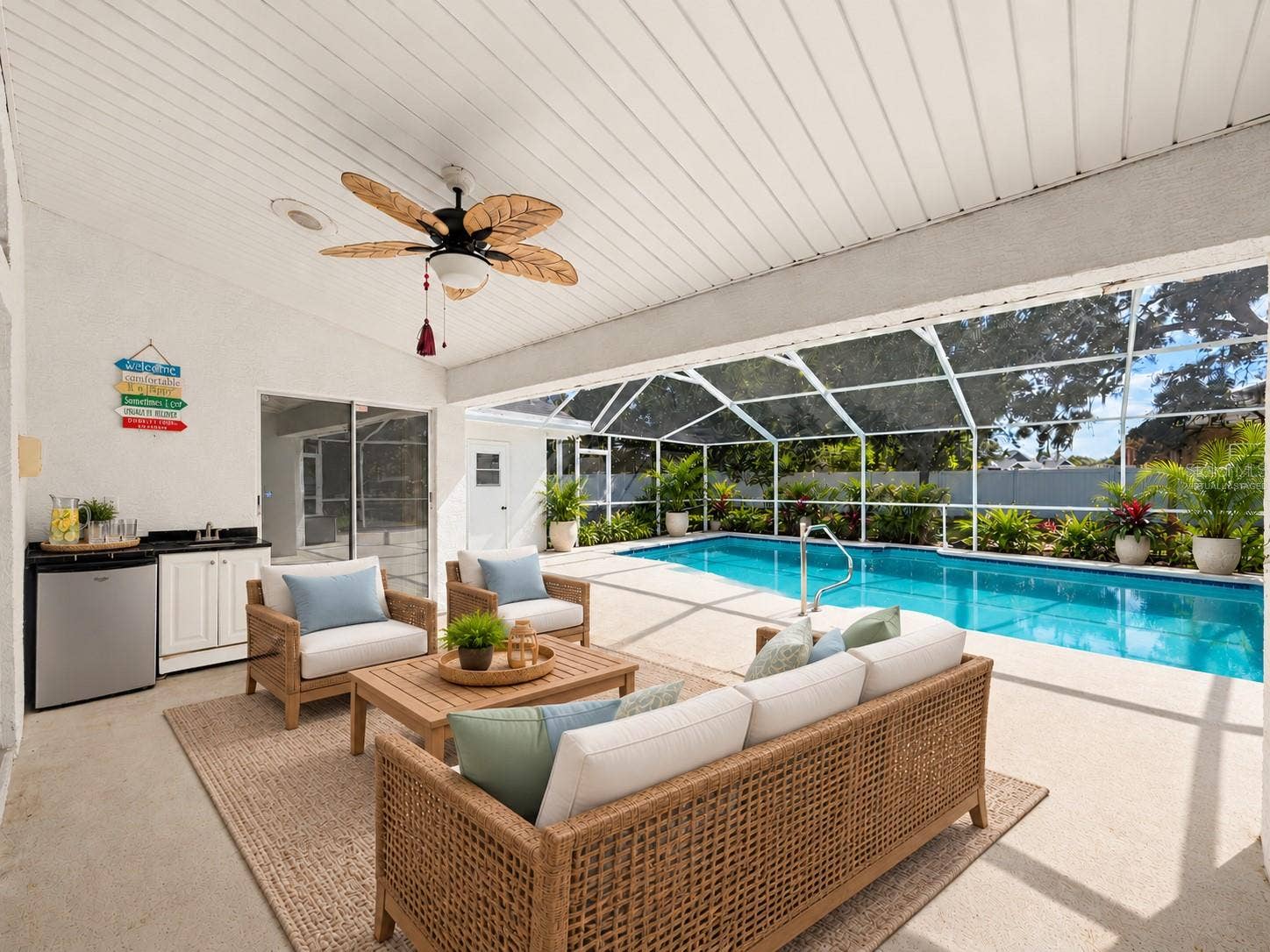 10074 SLEEPY WILLOW COURT, Spring Hill, FL 34608 Large covered patio with minifridge and sink. (virtually staged)