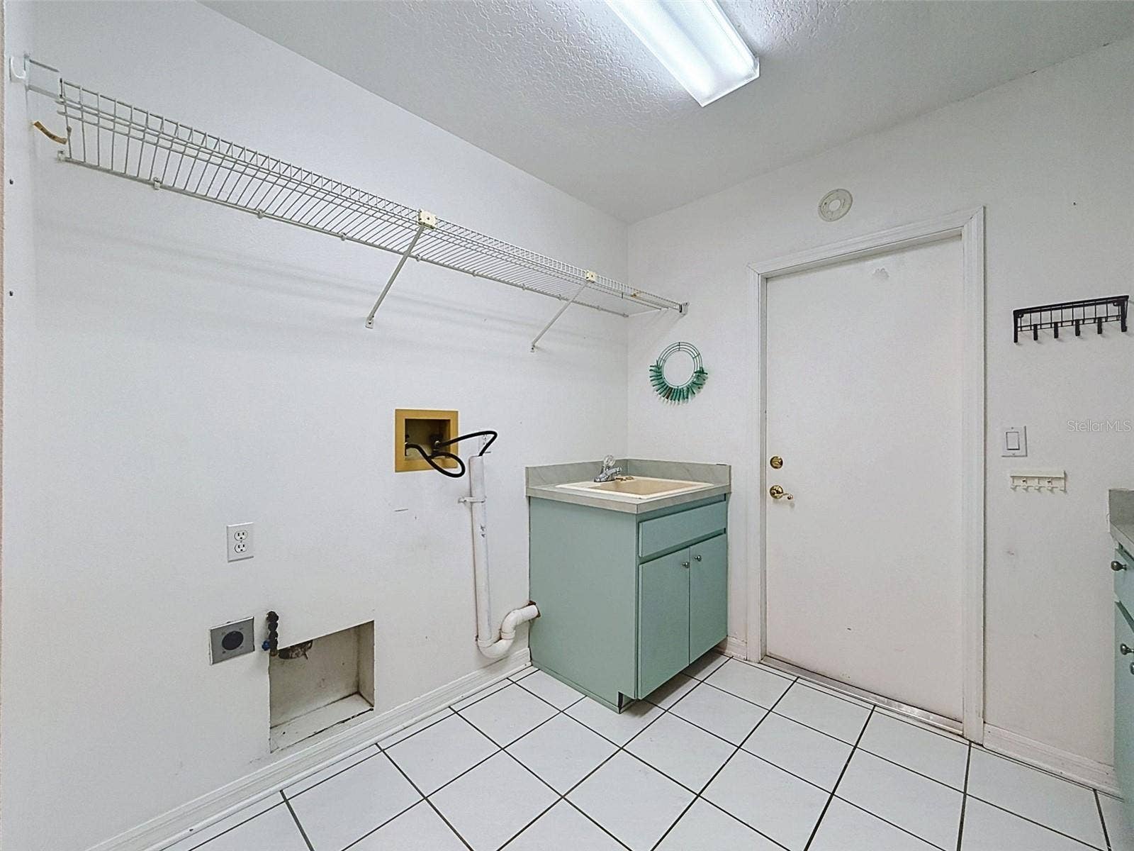 10074 SLEEPY WILLOW COURT, Spring Hill, FL 34608 Laundry room has storage gallore!