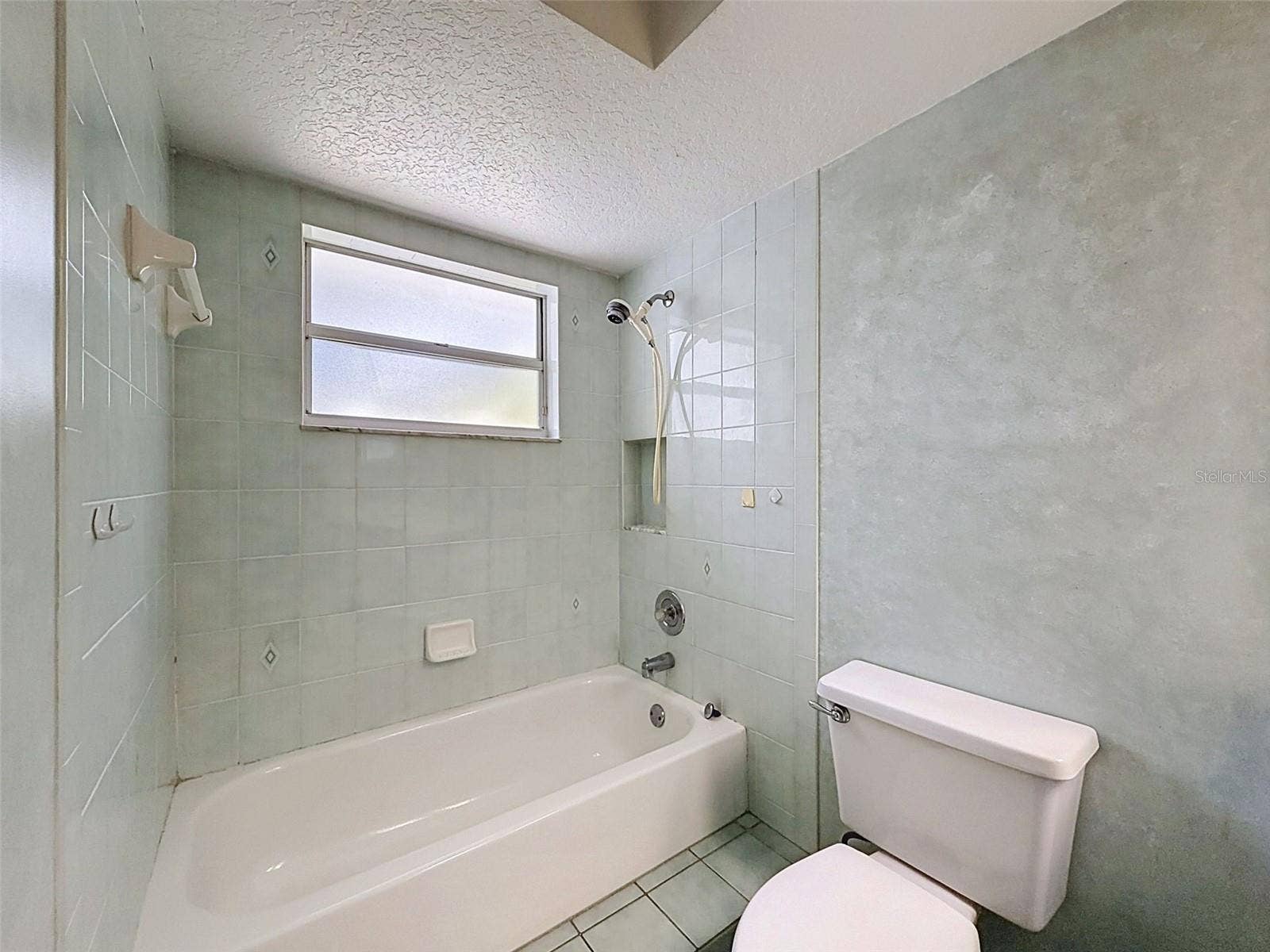 10074 SLEEPY WILLOW COURT, Spring Hill, FL 34608 Hall bathroom is large with lots of storage.