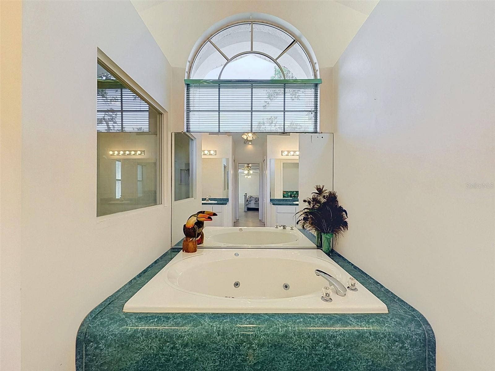 10074 SLEEPY WILLOW COURT, Spring Hill, FL 34608 Owner's suite includes jetted tub, two WICs, linen closet, water closet, two vanities, and large shower.