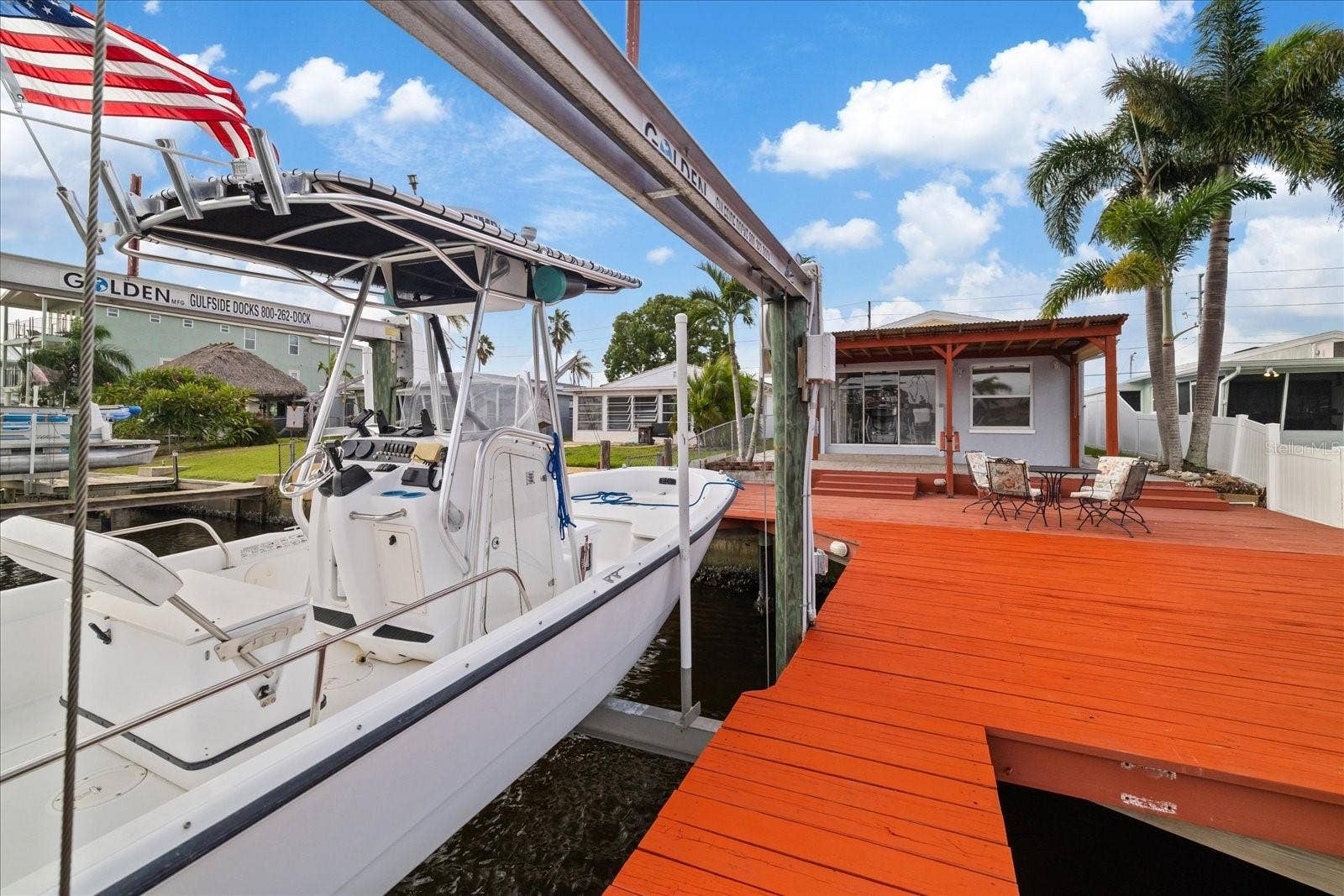 View from deck near boat lift looking south into back patio of home
