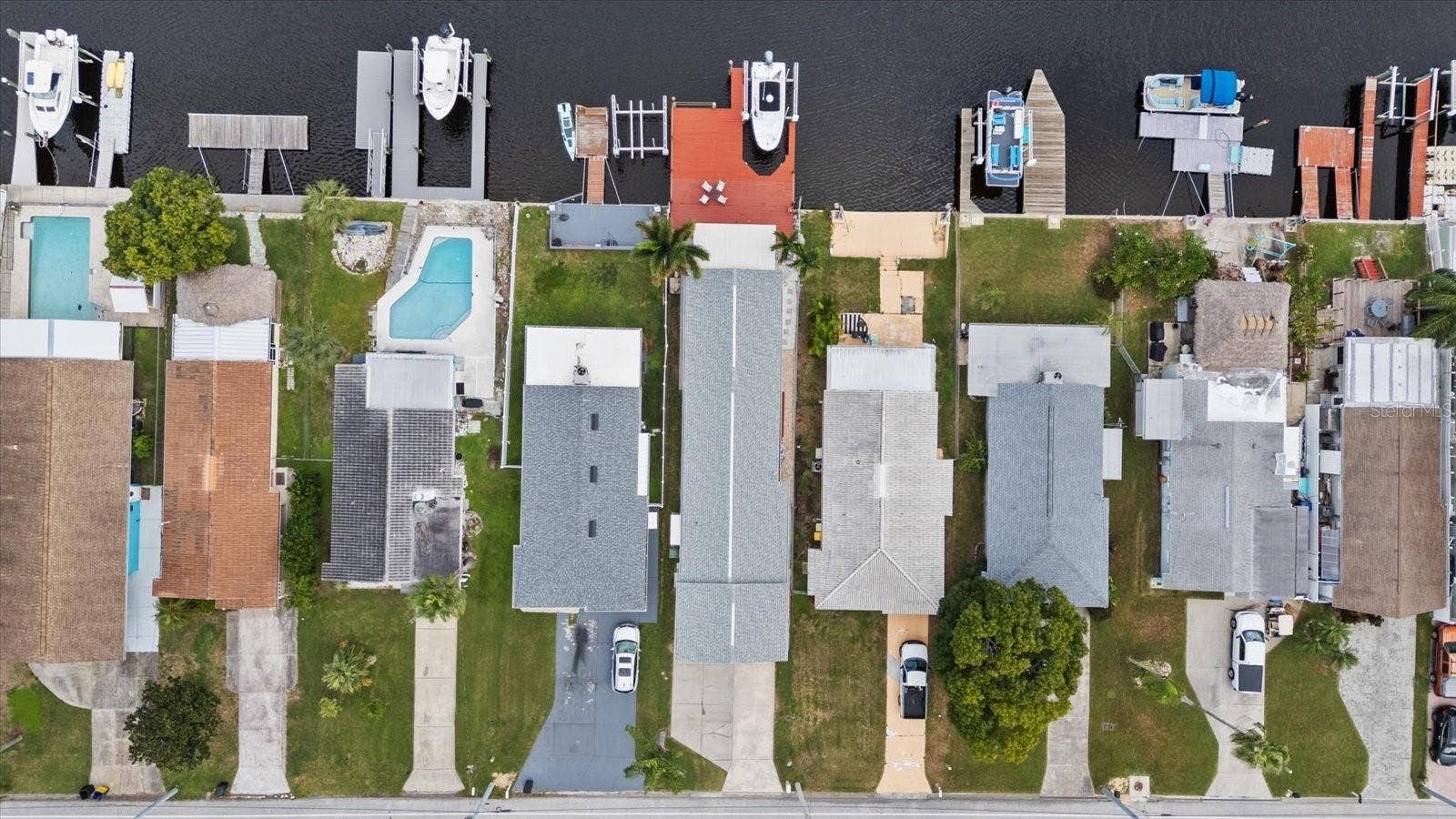 Aerial view of home with red deck and boat lift