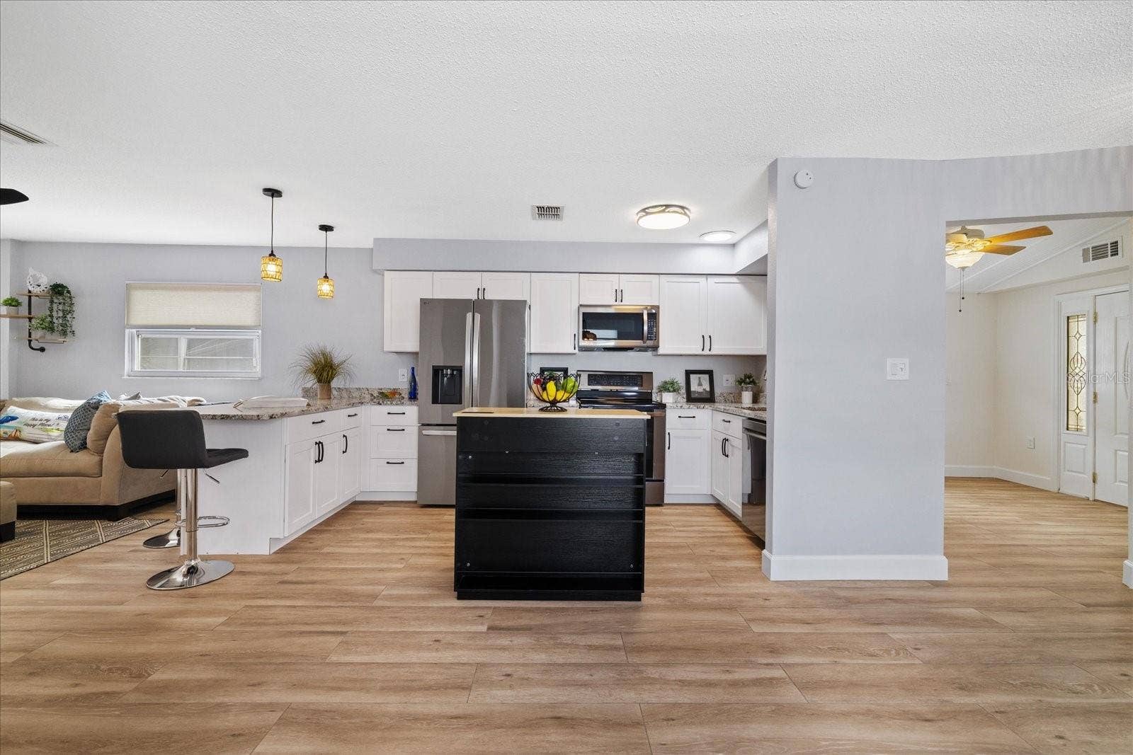 Looking from dining area toward kitchen and entry