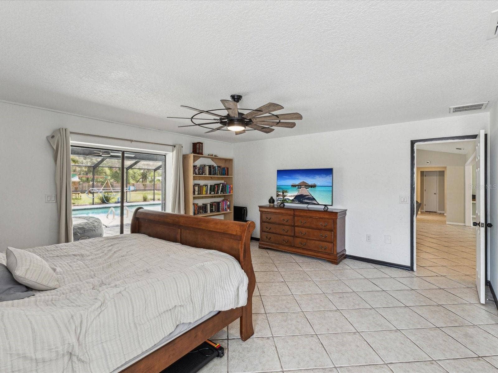 1222 HUNTINGTON AVENUE, Spring Hill, FL 34609 Primary Bedroom with Sliders to Patio and Pool