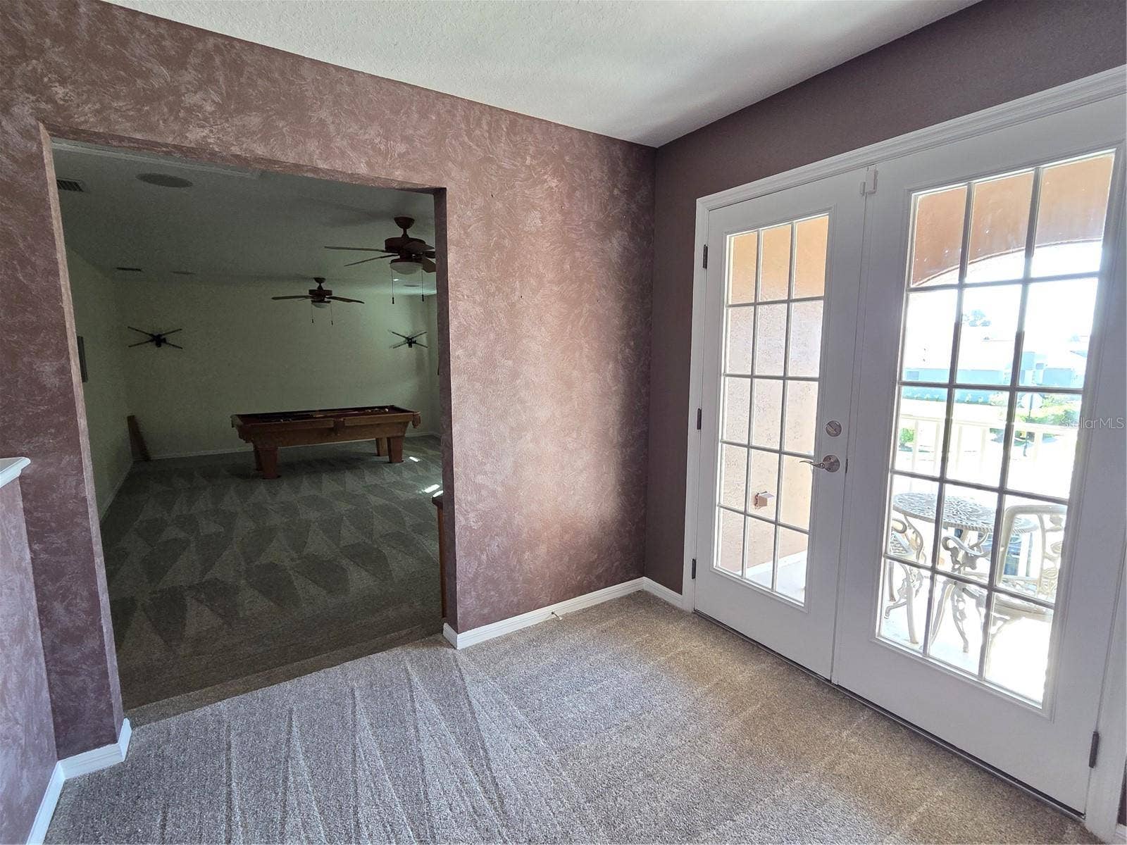 7711 ARELLI DRIVE, New Port Richey, FL 34655 Area upstairs outside bonus room and double doors to outside balcony
