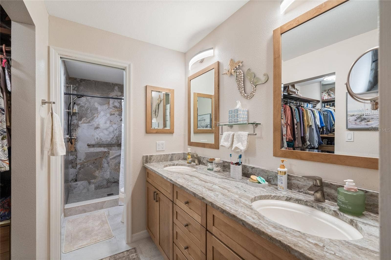 PRIMARY BATHROOM WITH WALK-IN SHOWER, DOUBLE SINKS AND MIRROWS AND GRANITE COUNTERTOPS.  SEPARATE TOILET ROOM WITH POCKET DOOR.  LARGE WALK-IN CLOSET.