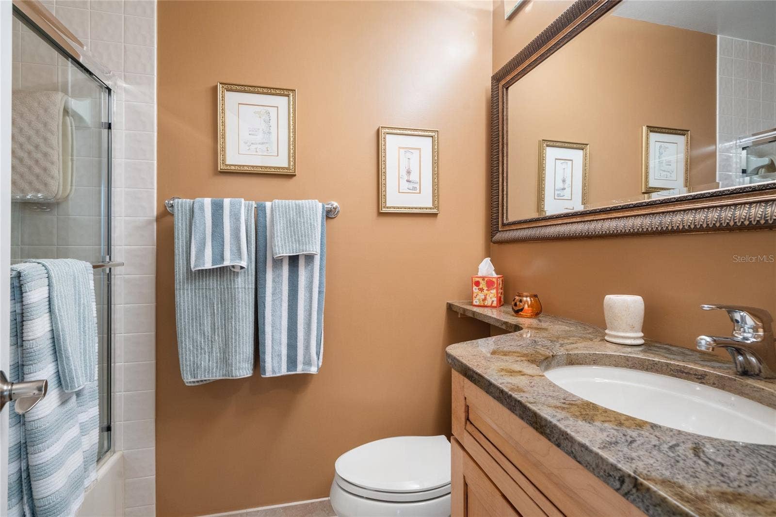 GUEST BATHROOM WITH GRANITE COUNTERTOP.