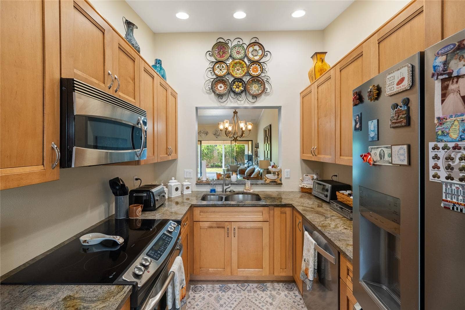 KITCHEN WITH CERAMIC TILE FLOOR, NEW KRAFTMAID CABINETS, STAINLESS STEEL APPLIANCES AND GRANITE COUNTERTOPS.