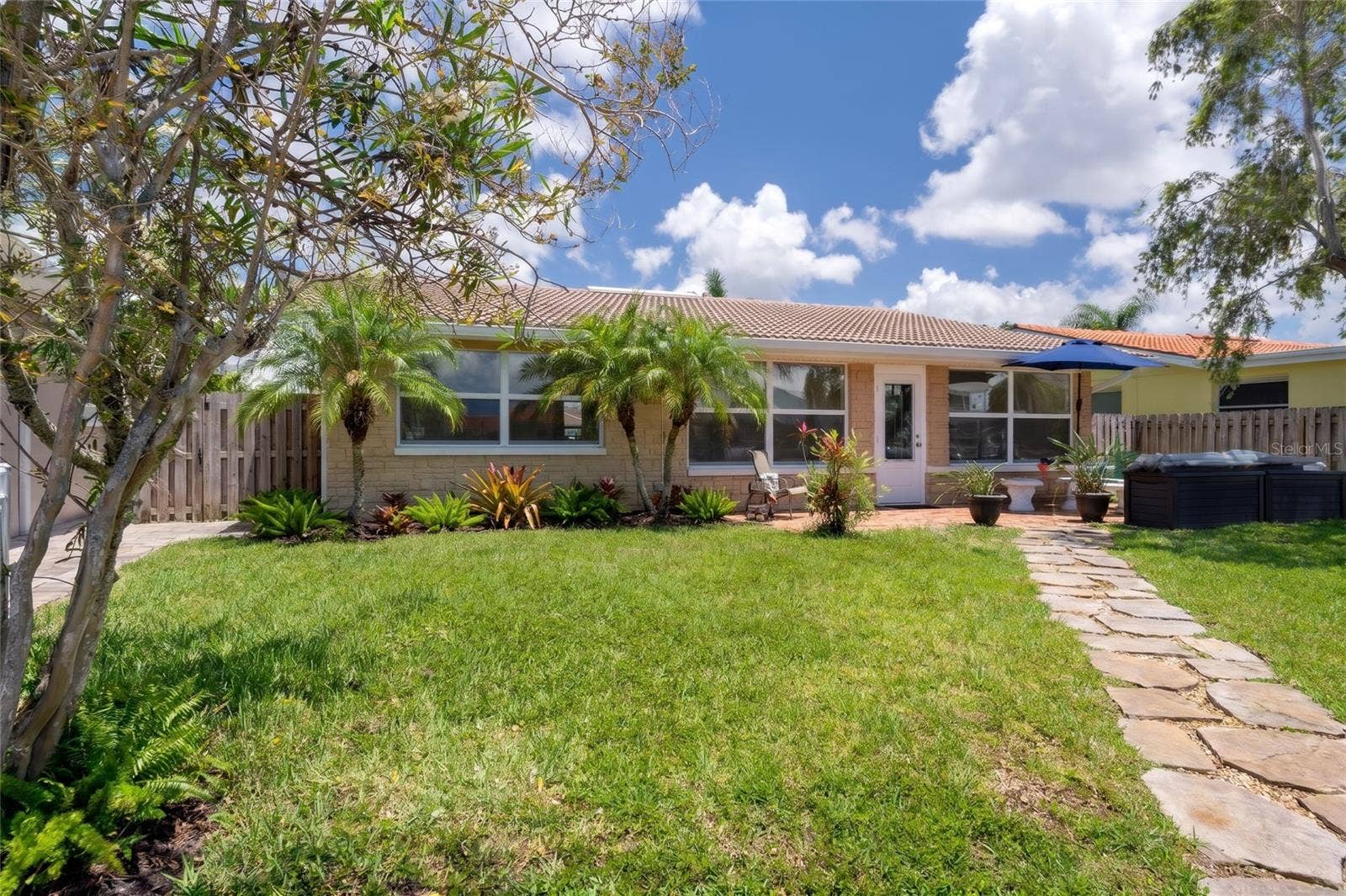 4937 DORY DRIVE, New Port Richey, FL 34652 Virtually added tropical items, plants and fence.