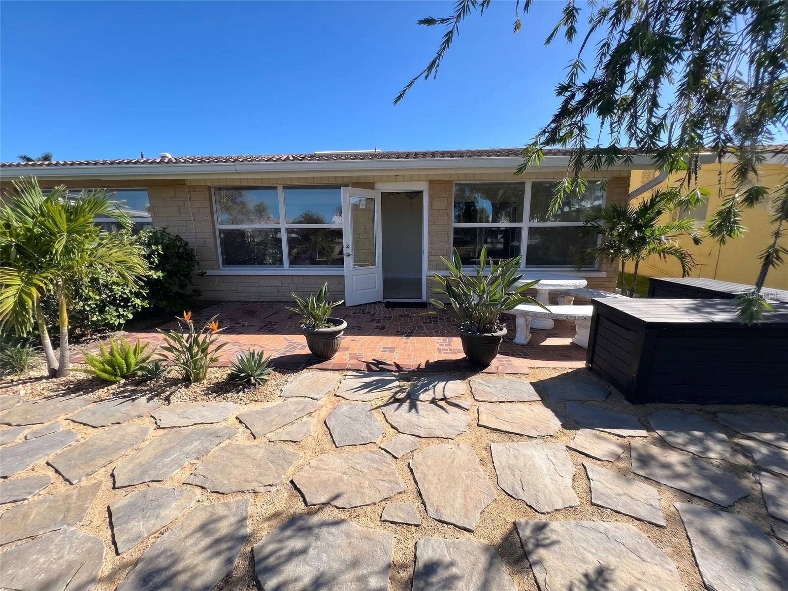 4937 DORY DRIVE, New Port Richey, FL 34652 Virtually stagged - this is an easy change to the backyard. added stones for a different look -
