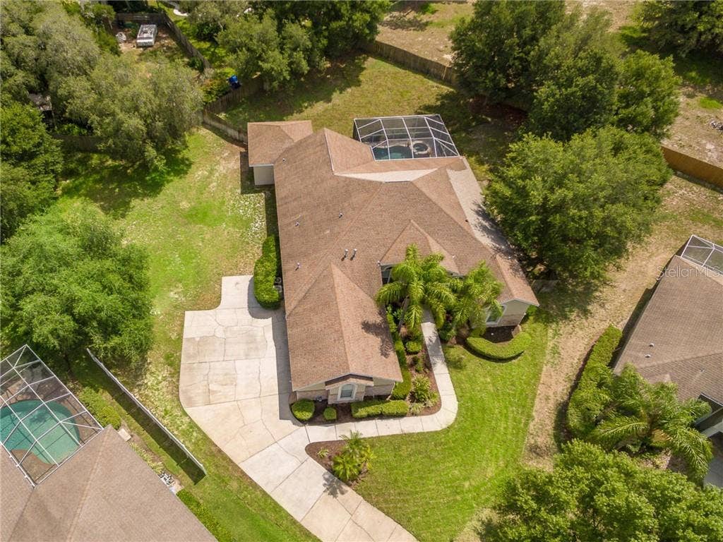 2911 HILLSIDE RAMBLE DRIVE, Brandon, FL 33511 Private, set back, executive home on the community's largest lot with .56 acres. Fenced behind pool area and open on the side of garage on the back side of home.