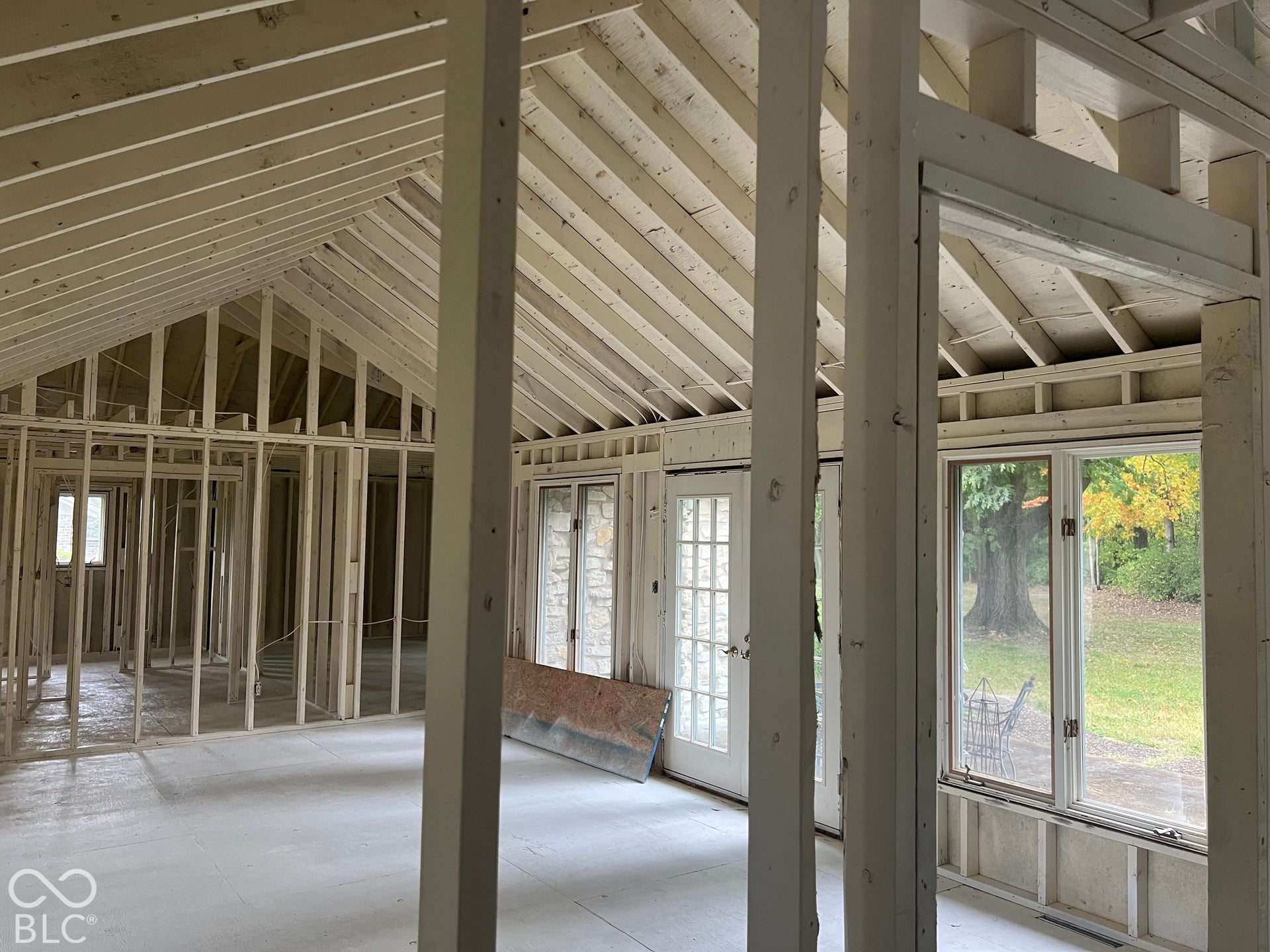 Living Room with vaulted ceilings and view of patio and backyard